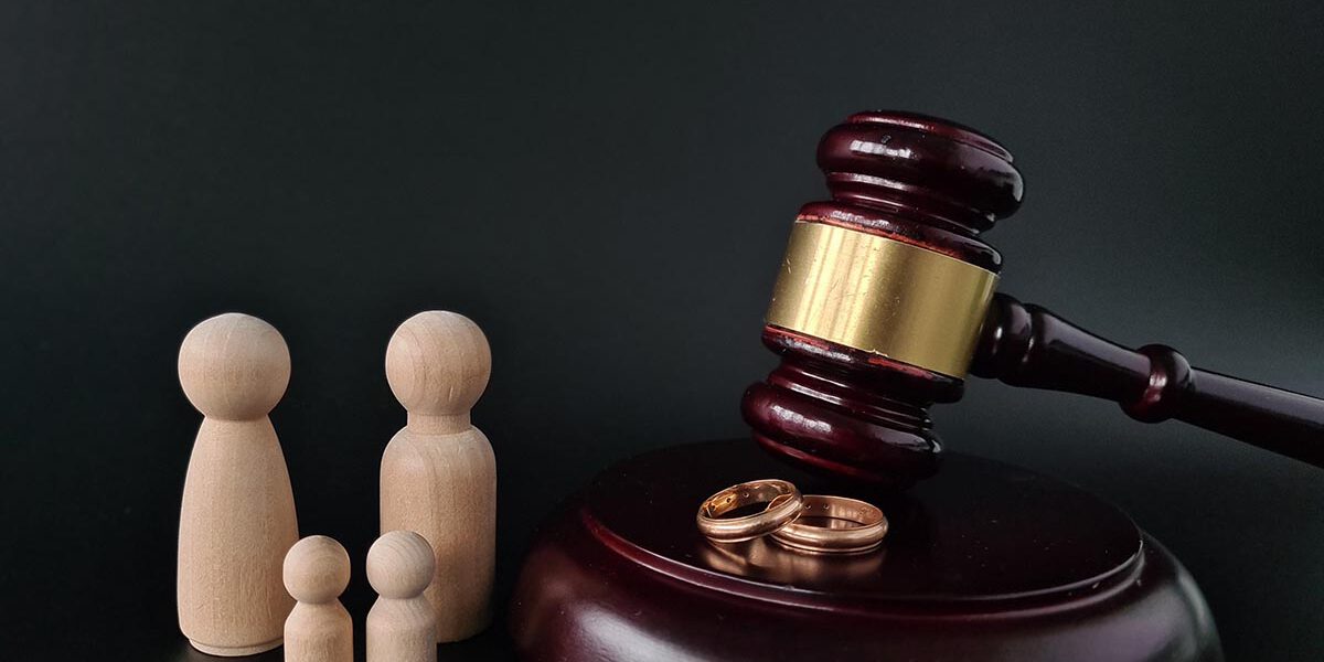 Wooden judge gavel and gold rings divorce concept