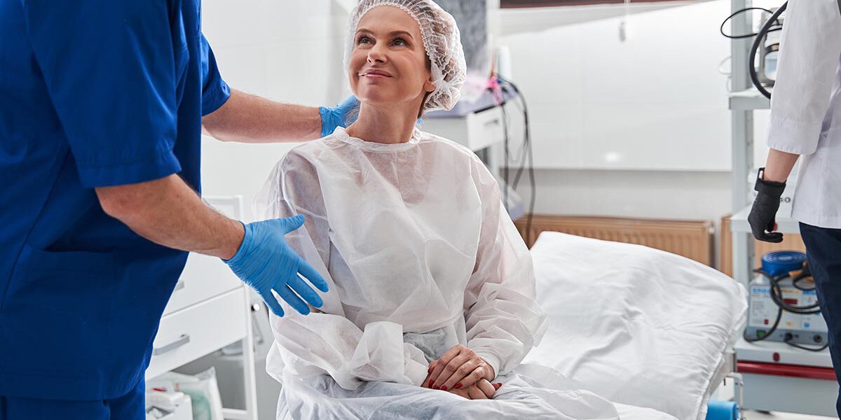 Man calming his patient before the gastroscopy at the modern clinic